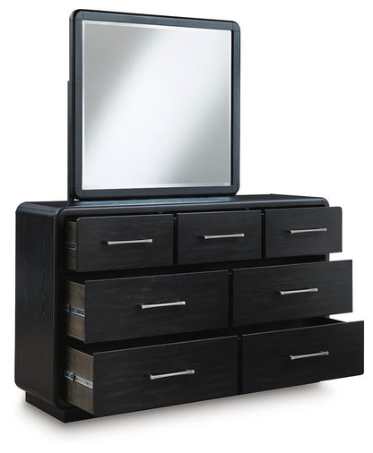 Rowanbeck California King Upholstered Panel Bed with Mirrored Dresser